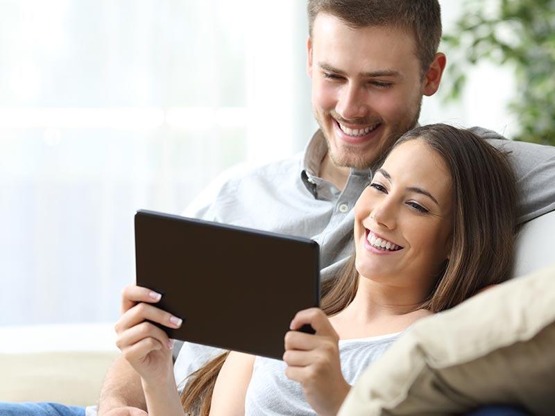 Couple holding tablet
